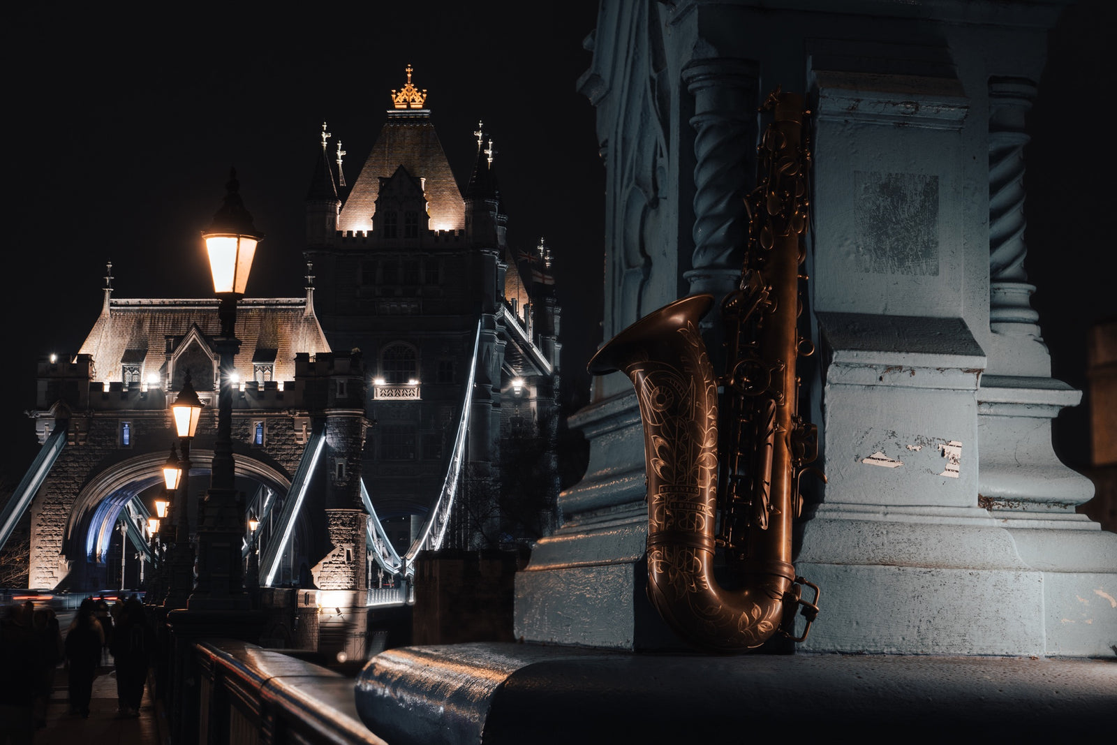 Atlantic London saxophone beside Tower Bridge illuminated at night