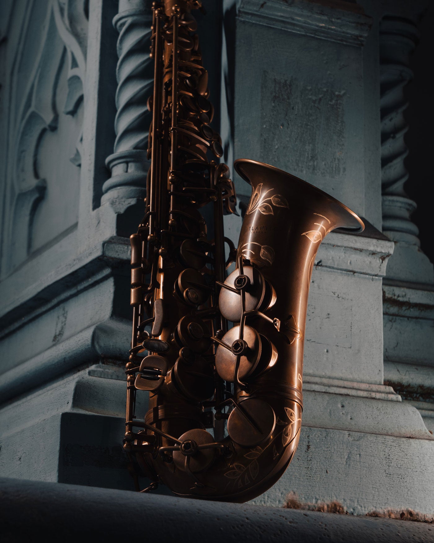 Atlantic London saxophone with warm bronze finish against carved stone